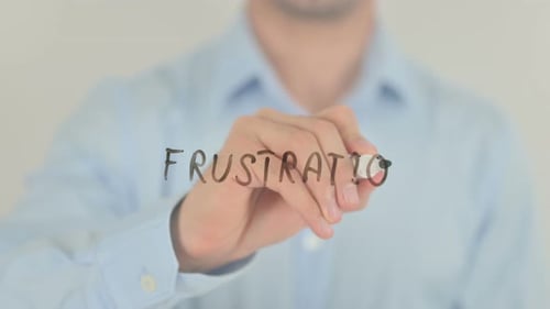 Hand Writing the Word Frustration With Marker