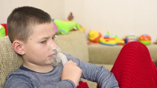 Young Boy Using Nebulizer at Home