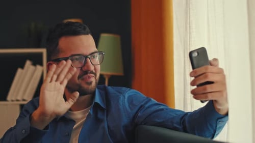 Young Adult Chatting on Video Call at Home