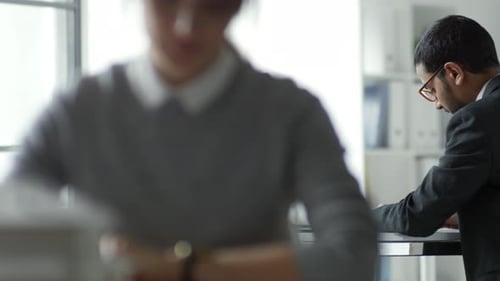 Office Worker Using Gadget at Desk