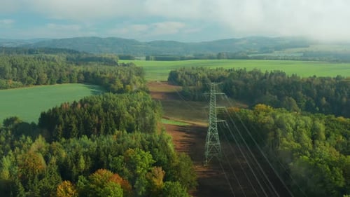 Flight Along High Voltage Power Lines and High Voltage Electric Transmission Tower or Pylon on the