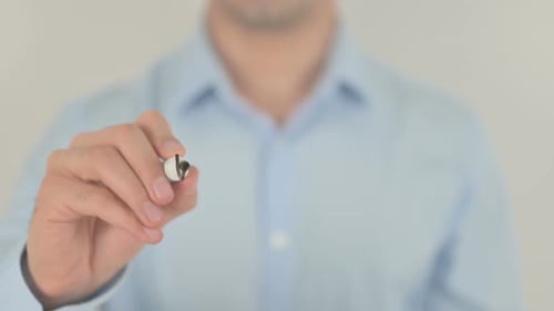 Hand Writes Workplace with Marker on Clear Surface
