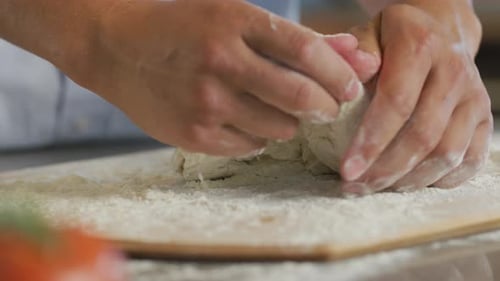 Close up of hands preparing fresh pizza dough