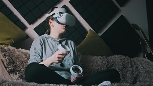 Woman Wearing VR Headset Relaxing on Couch