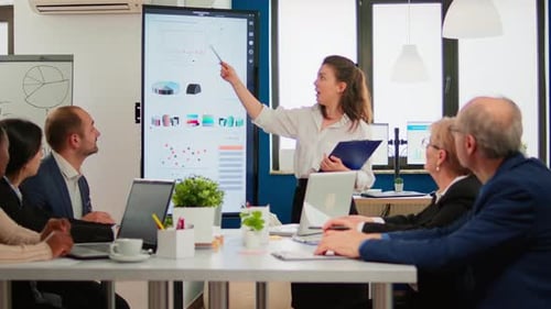 Data Presentation by Woman to Colleagues in Office