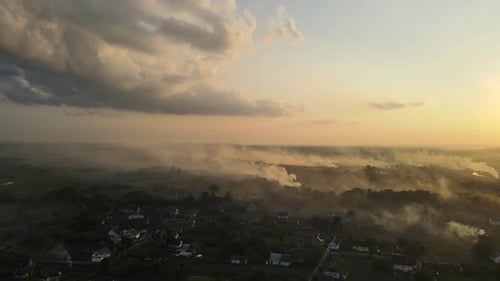 Aerial Shot In Ukraine At Sunset, Burning Grass. Emissions Into The Atmosphere