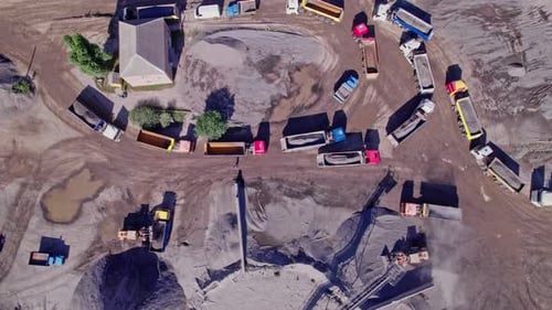 The Excavator Loads the Crushed Stone in a Truck