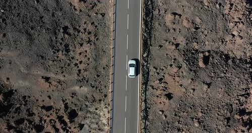 Aerial View. Driving on Road in Volcanic Rocky Desert Landscape.