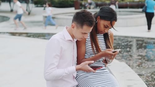 Black Girlfriend with Boyfriend on Date Not Talking, but Chatting with Somebody By Smartphones