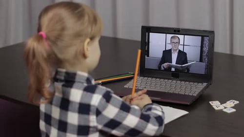 Girl Learning Online with Teacher on Laptop