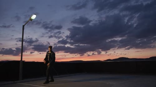 Young Adult Dancing on Rooftop at Dusk