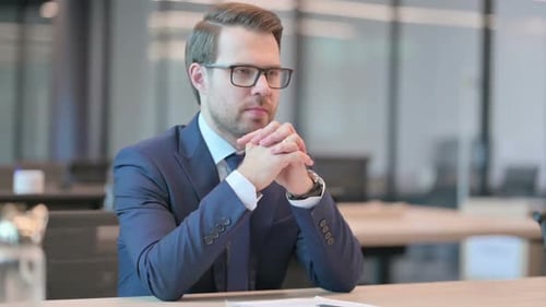 Pensive Businessman Thinking while Sitting in Office