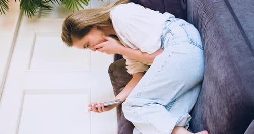 Woman Looking at Phone Appears Upset