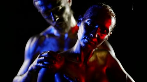 Painted Man and Woman Posing in Blue and Red Light