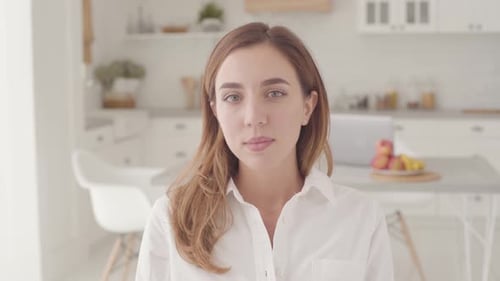 Smiling Woman in White Shirt in Bright Kitchen