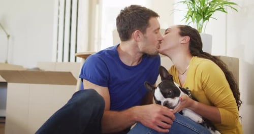 Romantic Couple Kisses with Dog in New Home