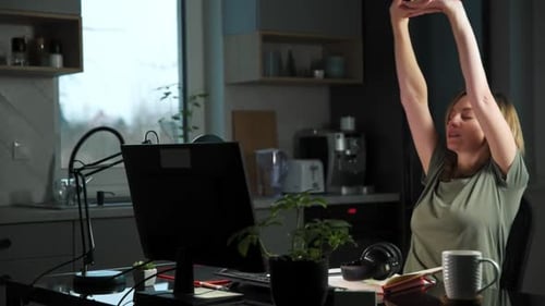 Woman Stretches While Working At Home Office