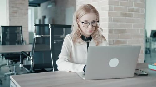 Woman Working on Laptop in Modern Office