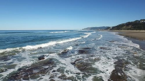 Coastal Beach with Waves and Rocky Formations