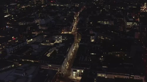 Forwards Fly Above Modern Urban Borough with Blocks of Buildings and Illuminated Streets