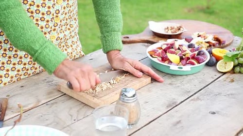 Woman chopping nuts outdoors