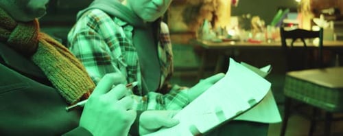 Actors Discussing Notes in a Gritty Indoor Setting