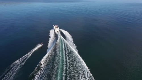 Speedboat with wakeboard rider into the sea