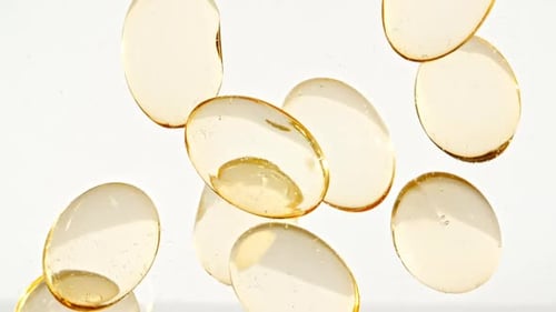 Vitamin Capsules Floating Slowly in Macro Shot