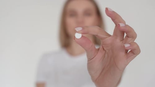 Woman Takes Pill, Close Up on Medicine