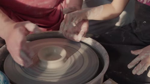 Hands Shaping Clay on Pottery Wheel