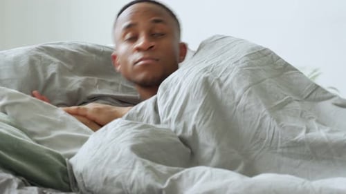 Young Man Sleeping Peacefully in Comfortable Bed