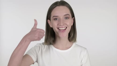 Smiling Woman Gives Thumbs Up on White Background