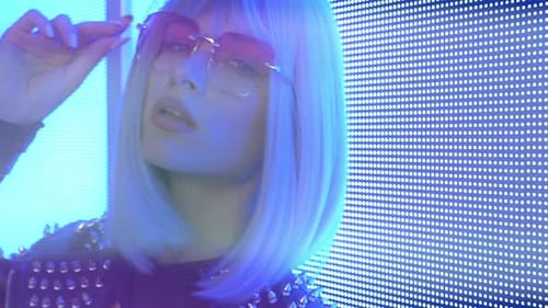Stylish Woman Poses in Front of Lights