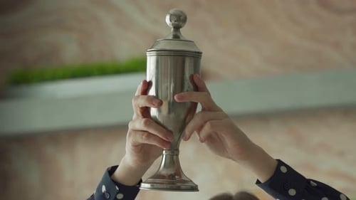 The Silver Cup in the Winner's Hand Rises