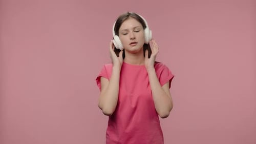 Teenage Girl Listens to Music on Headphones