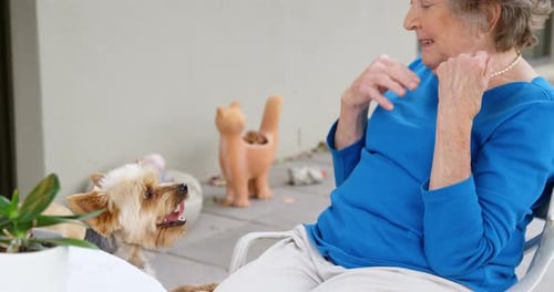 Senior Woman Playing with Her Dogs