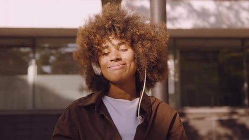 Woman Loving The Music From Her Headphones In Sunny City