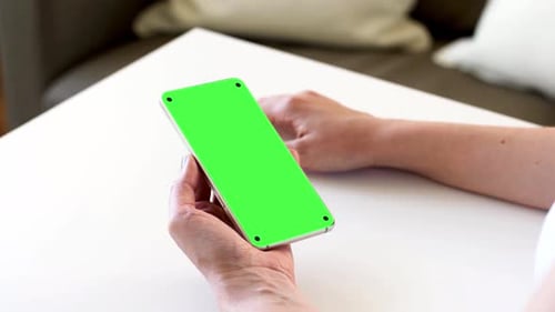 Hands Holding Smartphone with Blank Green Screen 2