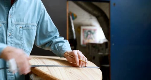 Man making surfboard 4k