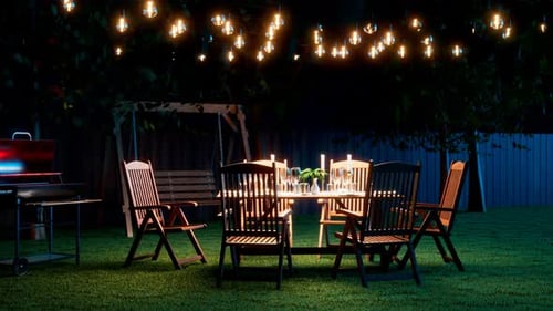Garden party. Nice outdoor lighting illuminates a well set table. Celebration.
