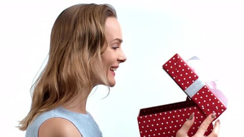 Woman Smiles Upon Receiving a Gift Box