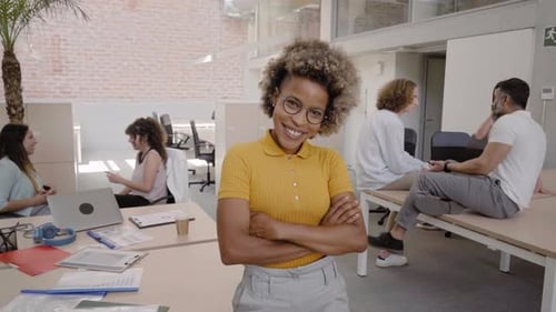 Confident Woman Smiling in Modern Office Workplace