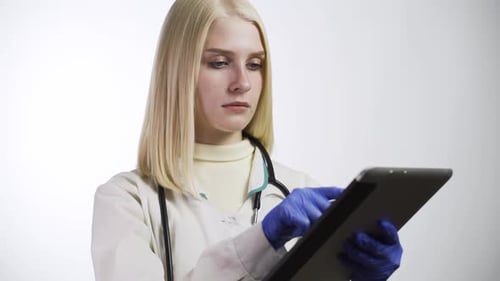 Young Adult Doctor Using Tablet in Clinical Setting