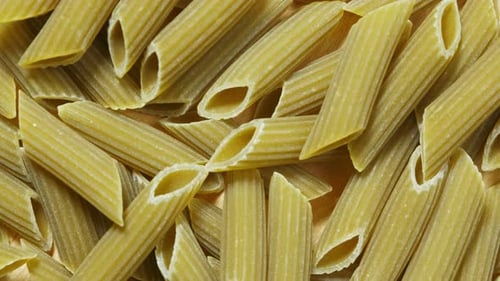 Pile of Green Penne Pasta Noodles Close Up