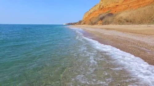Going back along the beach line next to the brown rocks