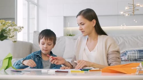 Woman and Child Draw Together at Home