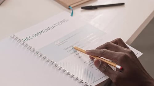 Businessman Looking Through Project Plan