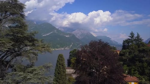 Aerial Flying Over Mountain Lake Como in Italy, Lakeside Villages and High Mountains on Horizon