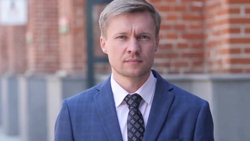 Man in Suit Reacts with Surprise in City