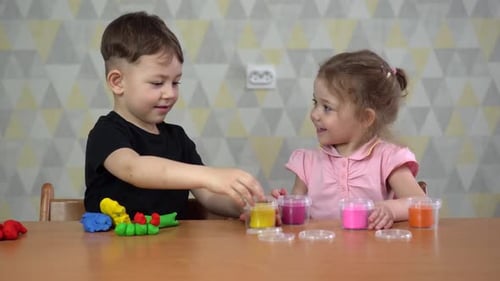 Boy and Girl Play with Colorful Clay